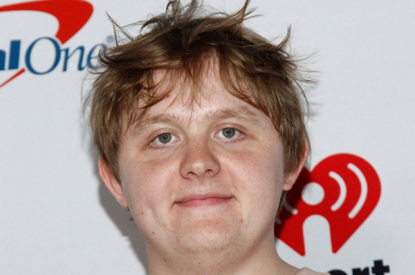 Lewis Capaldi performs amid flowers in 'Survive' music video